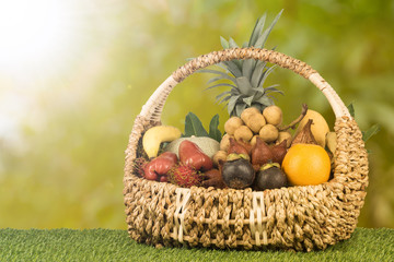 Tropical fruits inside basket with background