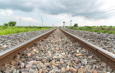 Fototapeta na wymiar Long straight railroad on concrete sleepers in a rural