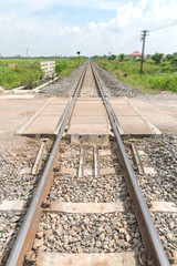 Long straight railroad on concrete sleepers in a rural