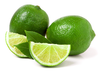 two limes with slices and leaf isolated on white background