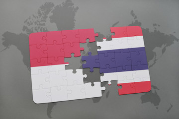 puzzle with the national flag of indonesia and thailand on a world map background.