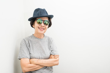 old women wear hat and sunglasses smailling with text space
