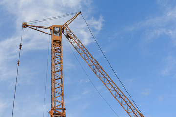 Tower crane against the blue sky. Building