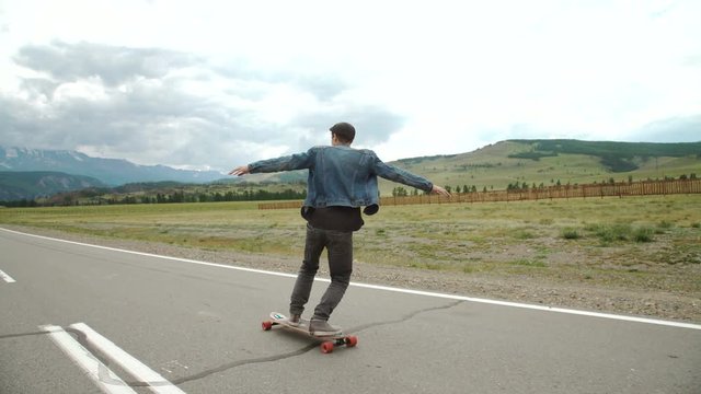 hipster man longboarding extremely action in highway.
