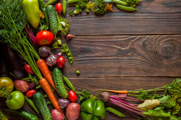 Fresh organic Vegetables on Wooden table with place for text. Healthy Vegetarian food, View from above.