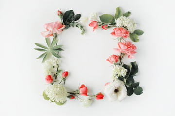 flat lay frame with pink and white roses, branches, leaves and petals isolated on white background. top view