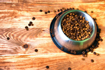 Full dog's bowl on wooden background