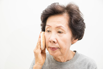 old woman applying make up