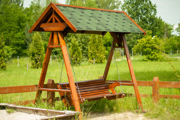 Wooden swing on the playground