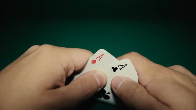 A pair of aces in a hand on the table. Pocker