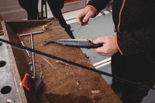 Fisherman filleting fish