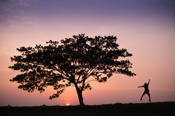 silhouette of man overjoy jump at sunrise