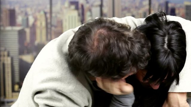 Man hugging girlfriend at home in New York