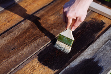 Paint brush on wooden table use for home decorated. House renova