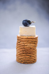 round crackers with camembert and grape