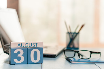 August 30th. Day 30 of month, wooden color calendar on manager workplace background. Summer time. Empty space for text