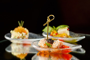 canapés for buffet on a black background
