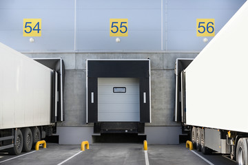 Trucks while loading in a big distribution warehouse