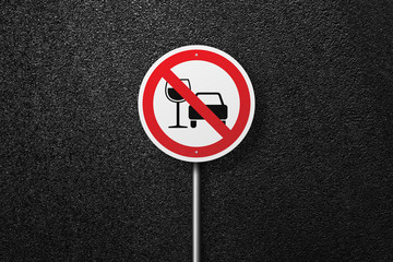 Road sign of the circular shape on a background of asphalt. No alcohol. The texture of the tarmac, top view.