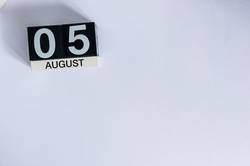 August 5th. Day 5 of month, wooden color calendar on white background. Summer time. Empty space for text