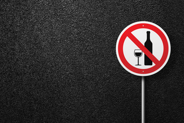 Road sign of the circular shape on a background of asphalt. No alcohol. The texture of the tarmac, top view.