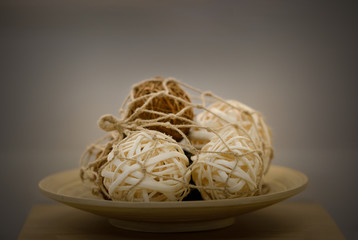 Brown straw balls in the wood plate
