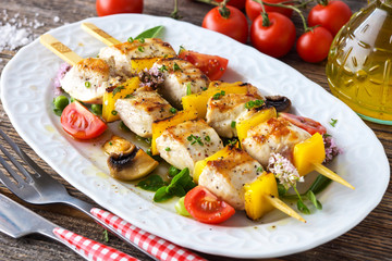 Griled Chicken skewers on wooden background