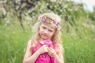 little blond girl with pink rose flowers