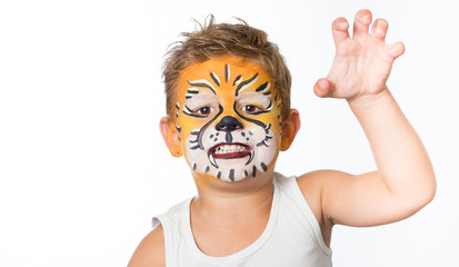 lovely adorable kid with paintings on his face as a tiger or lio