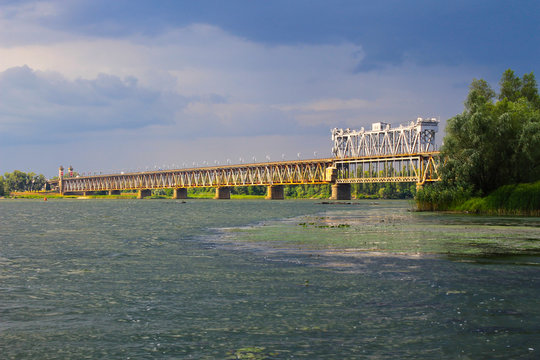 Bridge across river Dnieper and storm clouds in sky