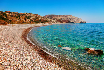 Beautiful beach on Petra tou Romiou (The rock of the Greek), Aphrodite's legendary birthplace in Paphos, Cyprus island, Mediterranean Sea. Amazing blue green sea and sunny day.
