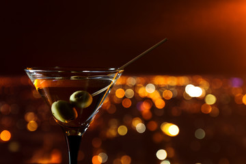 martini with olives on a background of night city