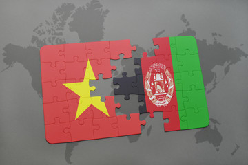 puzzle with the national flag of vietnam and afghanistan on a world map background.