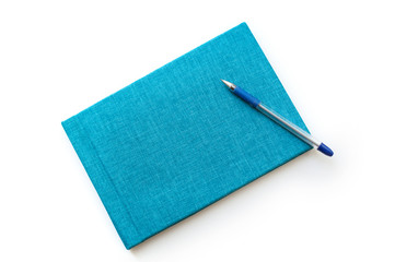 pen and turquoise notebook on a white background