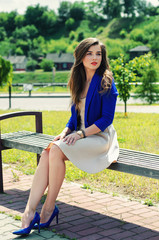 young beautiful girl sitting on bench