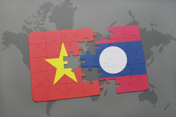 puzzle with the national flag of vietnam and laos on a world map background.