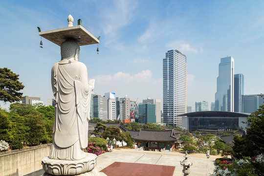 Mireuk Daebul statue (The Great Statue of Maitreya Buddha) at the Bongeunsa Temple and view of Gangnam in Seoul, South Korea.