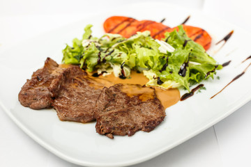 A beautiful meat dish on a white background
