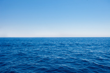 Background of sparkling sea water on a bright sunny day. Sea and sky