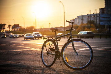 Fototapeta premium Classic city bike on the road at sunset