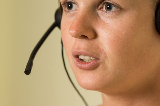 Female call center worker with headset. High resolution image de