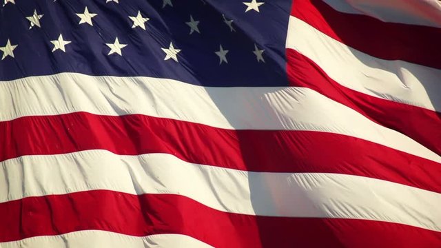 US Flag unfurling in the breeze. Shot with a high-speed camera.