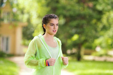 Portrait of a young woman jogging in a park