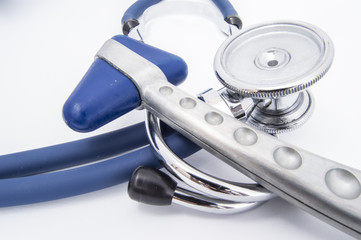 Stethoscope and neurological hammer lying on a table in the doctor's office. The tool for the...