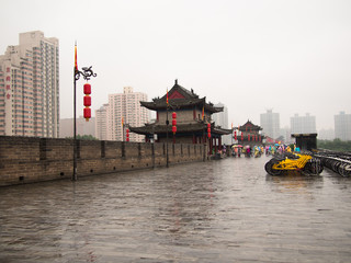 Chinese house stands on a bridge near Bicycle parking on a background cloudy sky