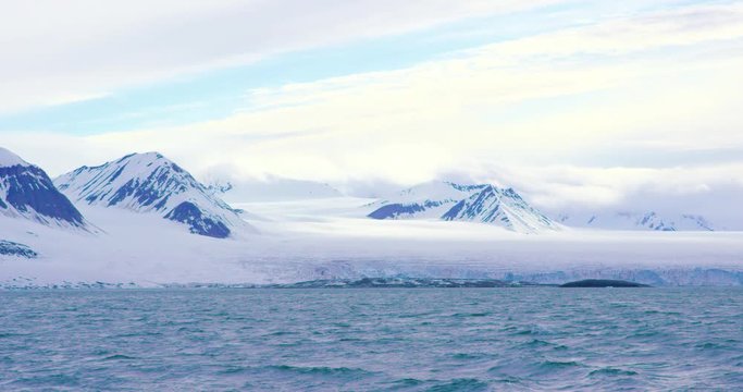 Mountains and a massive glacier in the arctic