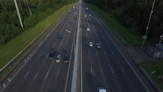 Aerial view of traffic on a motorway ring road through a wooded area