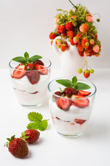 Layered strawberries cream cheese dessert on white background