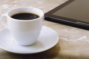 Fototapeta na wymiar Black coffee and a tablet