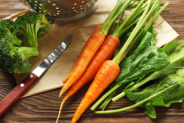 Carrots with herbs on wooden table